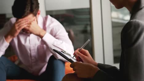 depressed man talking to counselor