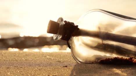 message in the bottle against the sun setting down