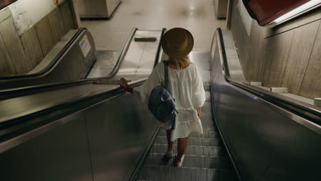 Woman riding down an escalator in the subway