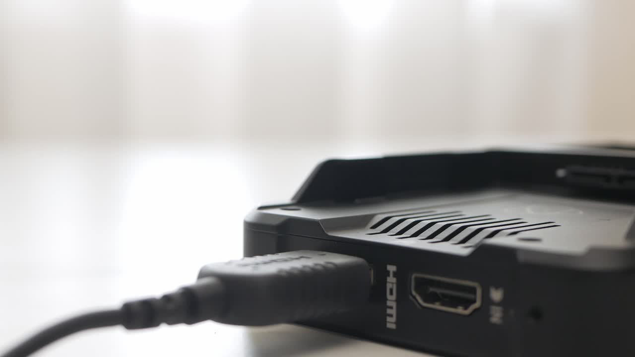 Man hand plug and unplug HDMI cable into external monitor closeup