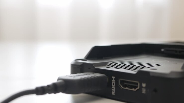 Man hand plug and unplug HDMI cable into external monitor closeup