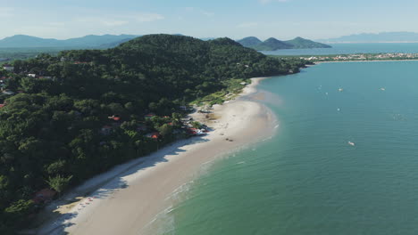 bird's-eye view captures the serene forte beach in santa catarina along the brazilian coast, with its calm, emerald-green waters creating a tranquil and inviting atmosphere