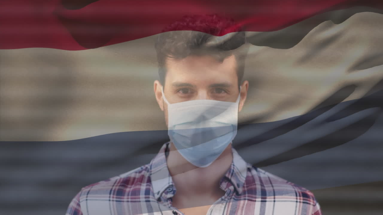 코로나19 전염병 기간 동안 마스크를 쓰고 있는 남성 위에 날아다니는 네덜란드 국기의 애니메이션