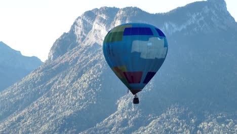 hot air balloon with stunning alpine peaks in the background