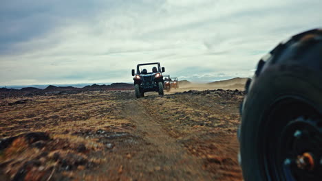 column of atv vehicles exploring the wild volcanic landscapes of iceland