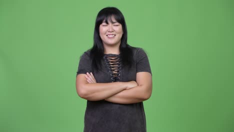 beautiful overweight asian woman smiling with arms crossed