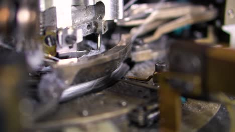 The-process-of-manufacturing-of-socks-on-a-loom---Close-up-shot-of-Spools-with-white-thread-at-rewinding-machine-video