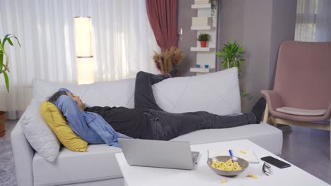 exhausted or bored man falls on the couch.