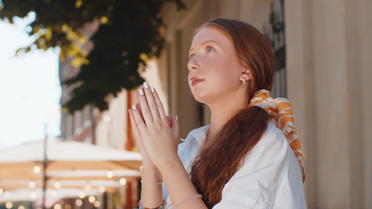 Portrait of teenager girl praying closed eyes to god asking for blessing help forgiveness outdoors