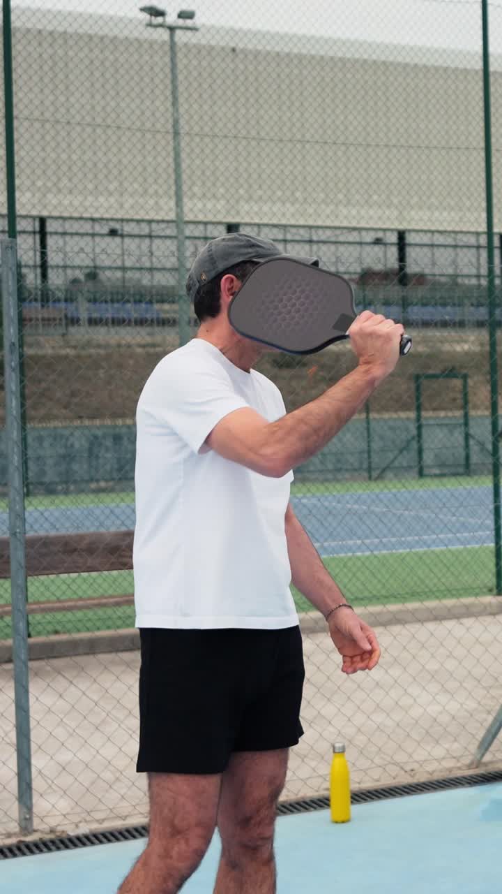 Happy Man Playing Pickleball on an Outdoor Court