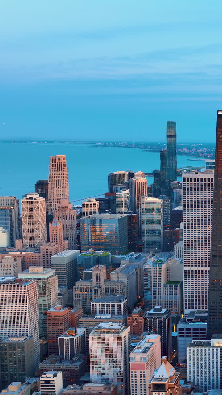 Aerial perspective gives a view of the downtown Chicago skyline out towards Lake Michigan. Vertical video