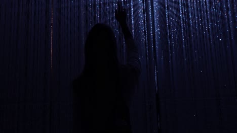 immerse yourself in the world of teamlab planets in tokyo, where art meets digital visuals. in this captivating video, a girl experiences the enchanting blue-hued lights in a dark, futuristic scene.