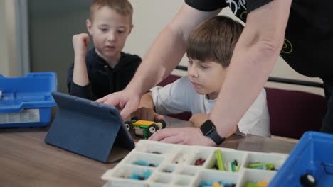 children engage in stem learning activities, assembling robotics kits with focus and teamwork in a classroom setting