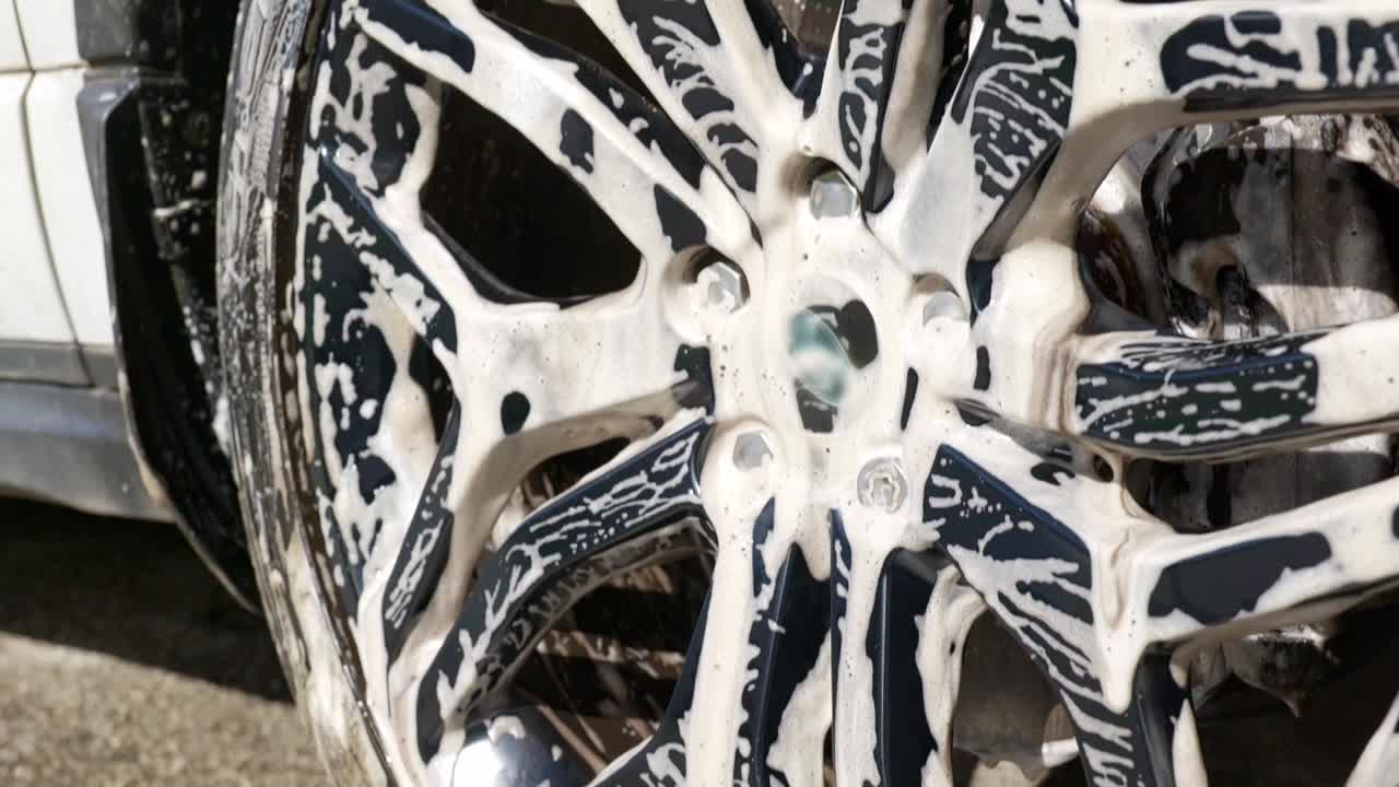 Dirty shampoo suds on black wheen after cleaning - top to bottom