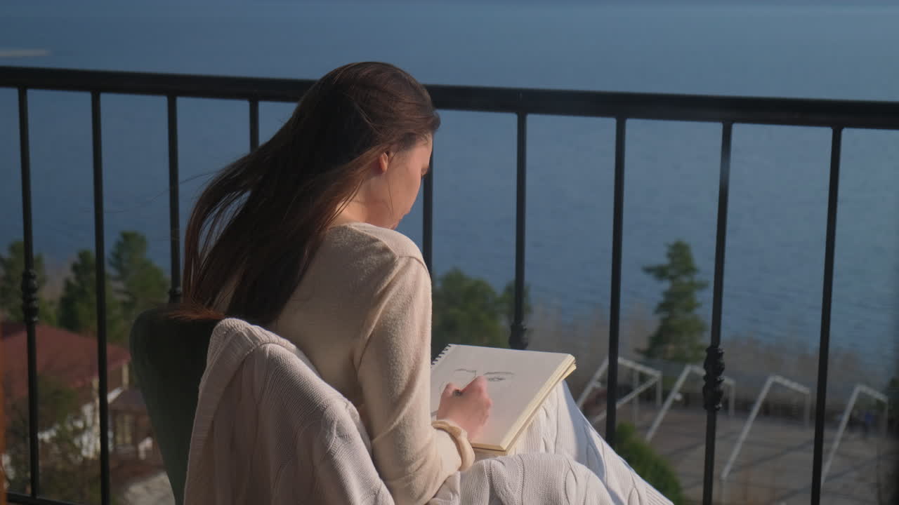 Woman Drawing on Balcony with Lake View