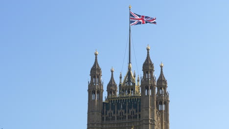 Static-shot-of-top-of-Victoria-Tower-with-Union-flag-flying,-sunny-day