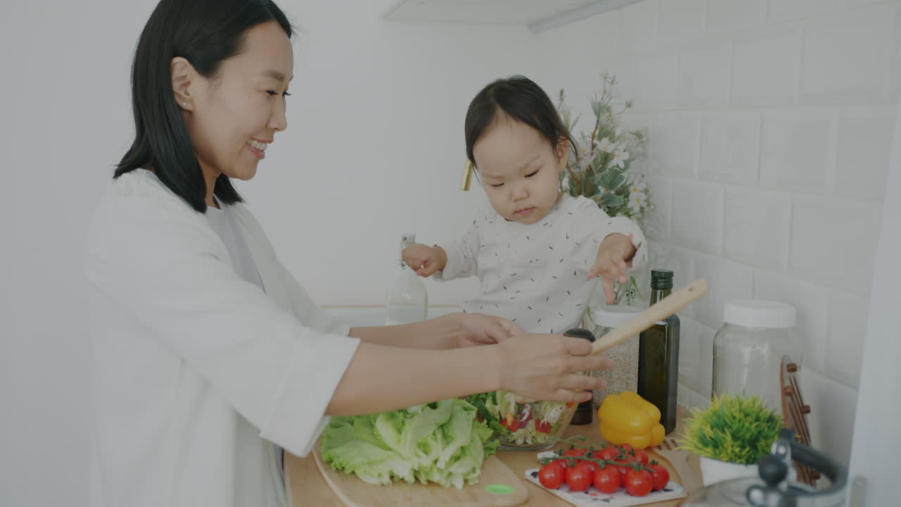 Mother and Daughter Making Salad Together