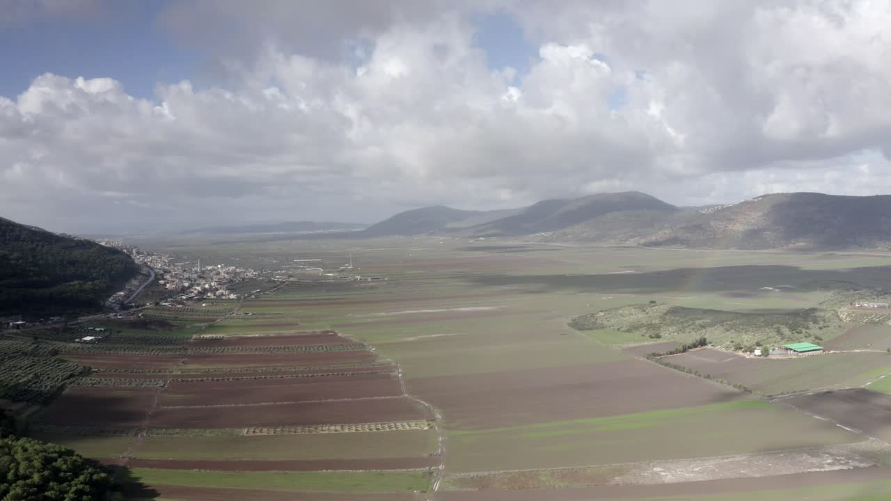 Aerial View of a Valley with Fields and Mountains