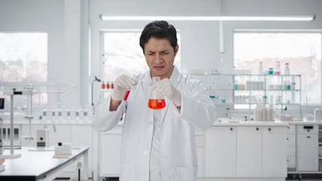 confused indian scientist mixing chemicals for experiment