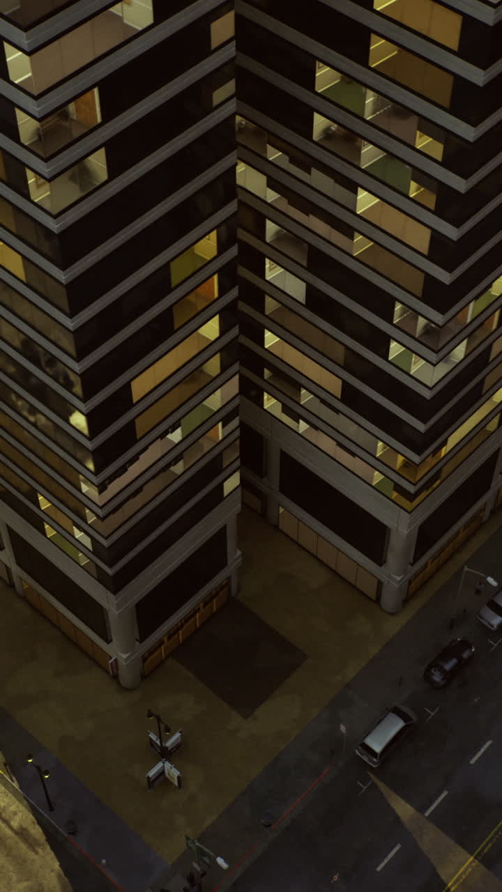 City landscape at dusk with illuminated buildings and quiet streets