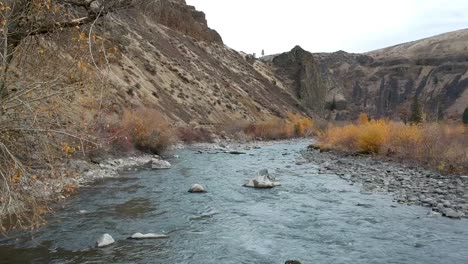 Ariel-drone-footage-of-a-rugged-river-valley-in-fall