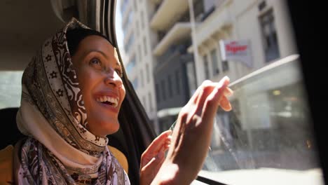 young woman wearing hijab out and about in the city