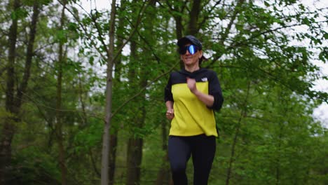 Female-runner-running-outside-in-forrest---low-slow-motion-shot