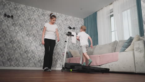 dedicated female trainer supervises young boy performing treadmill workout in cozy home setting, focusing on posture and safety during energetic training session with soft natural lighting