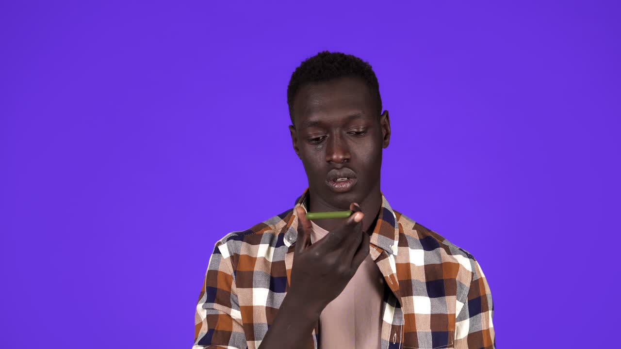 and intelligent technology. Young guy in plaid shirt talking to smartphone using digital voice app to search data, make order