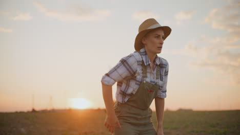 tired female farmer at sunset