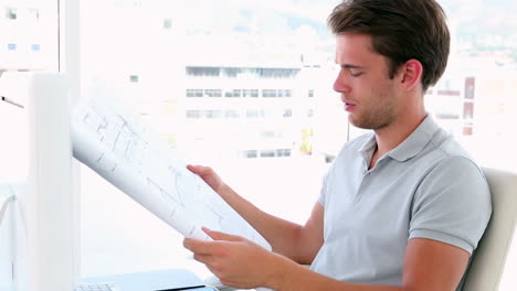 Architect-working-at-his-desk