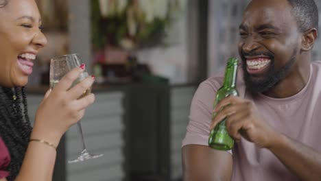 Tracking-Shot-of-Man-and-Woman-Toasting-Drinks-While-On-a-Date-In-a-Bar