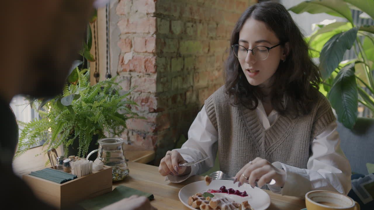 Woman Eating Waffle in a Cafe