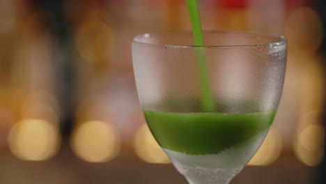 green cocktail pouring
