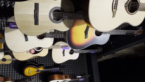 acoustic guitars in a musical instrument store. beautiful multicolored guitars. the concept of stringed musical instruments