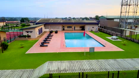 swimming pool in a resort with a green lawn