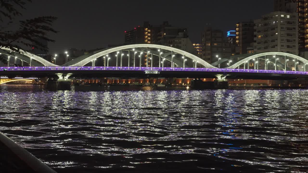 Night view of a bridge over water in a city