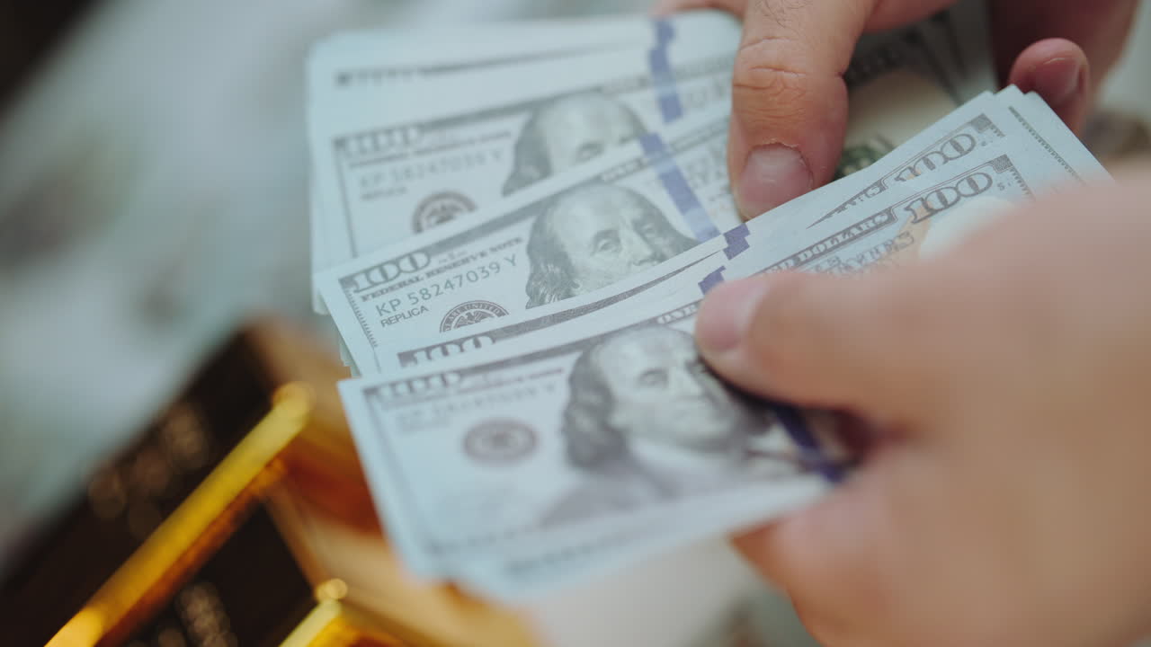 Stacks of US Dollars and Gold Bars