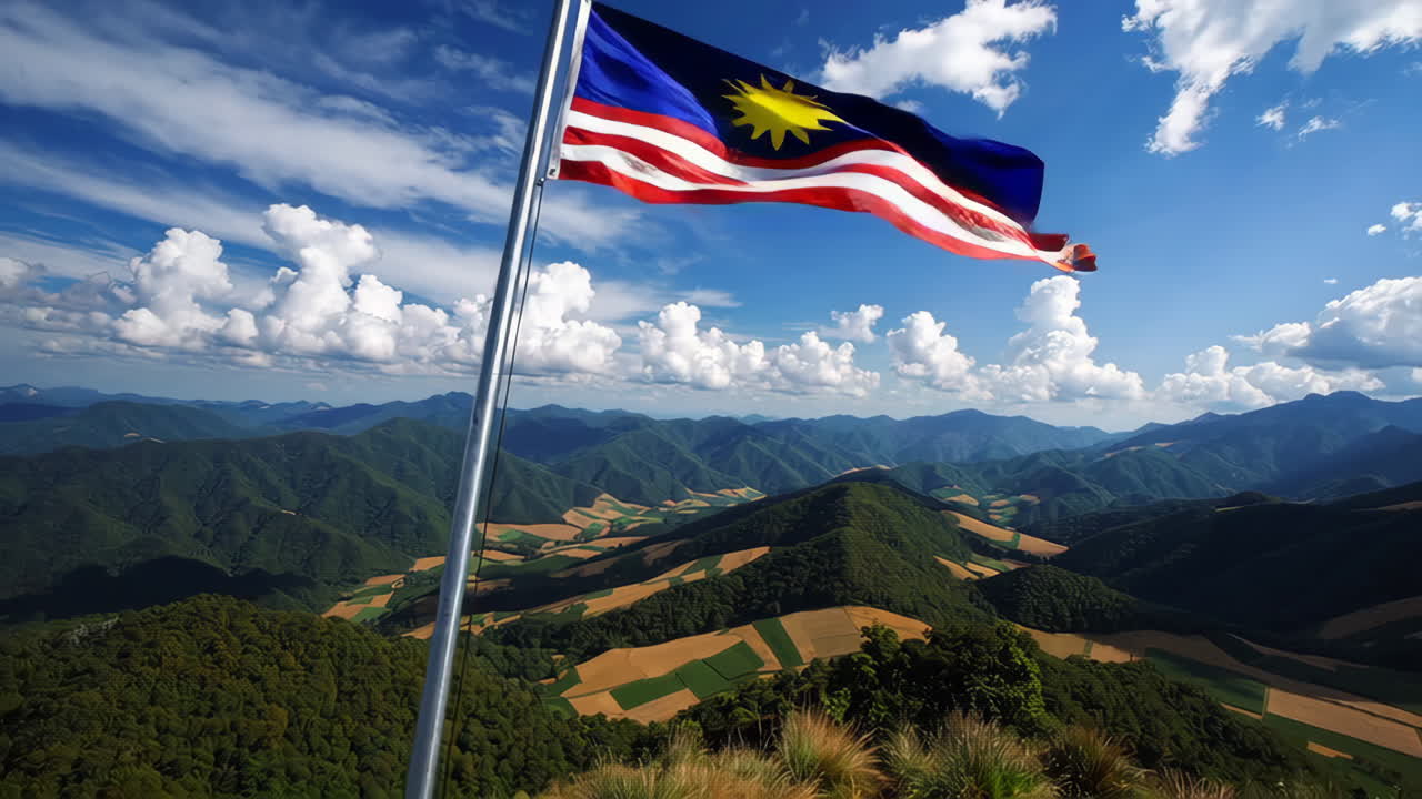 Malaysian Flag over Mountainous Landscape