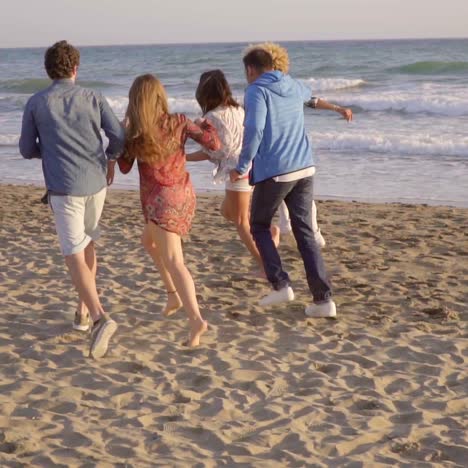 young people running on the beach