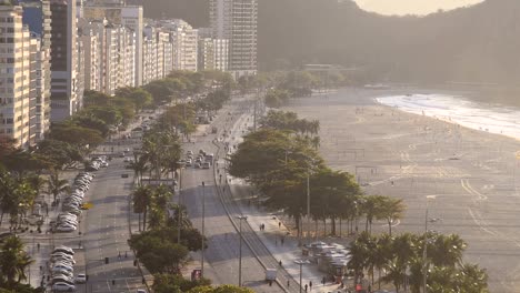 early morning sunrise and traffic at copacabana beach in rio de janeiro