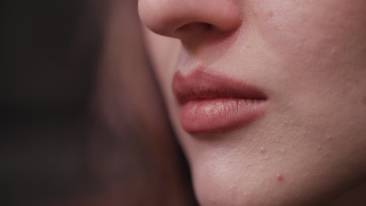 Close up of lady lips as she brings creamy waffles toward mouth, highlighting soft natural lip texture and food movement in slow delicate action during quiet indoor moment