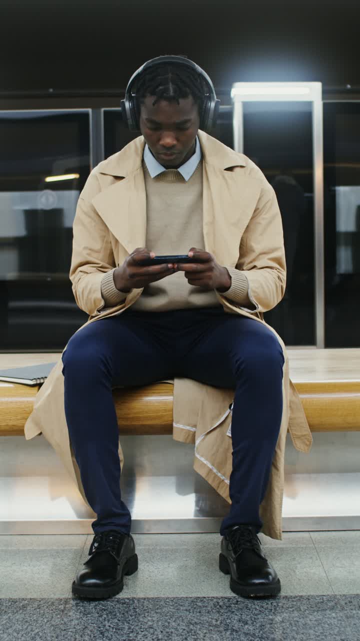 A man with headphones at the subway