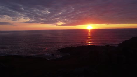 Bright-Red-Sunset-Over-the-Sea-on-the-Isle-of-Coll,-Hebrides,-Scotland