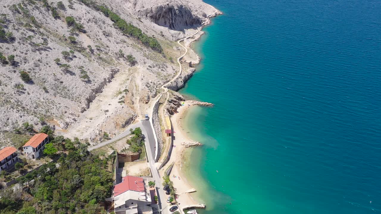 Metajna shoreline on the island of Otok Pag in Croatia with road near the ocean cliffs, Aerial flyover view