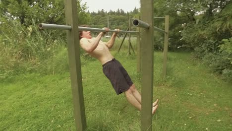 young man performing straight bar pulling exercise on home gym