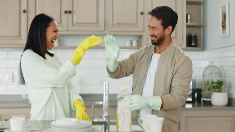 Couple,-cleaning-and-high-five-in-kitchen