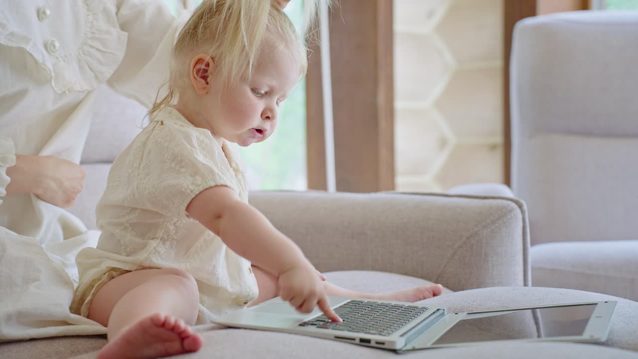 Baby girl interacting with a laptop