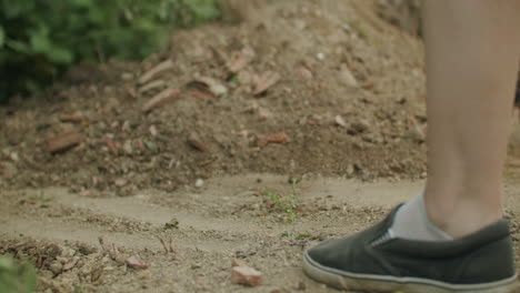 handheld low angle shot of a female using a shovel