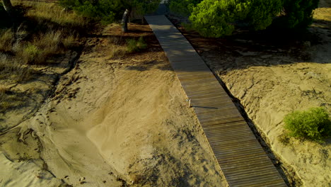 Wooden-Walkway-Through-Trees-And-Dry-Landscape-Near-El-Rompido-City-In-Spain